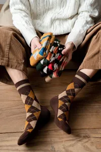 Men's cozy thick argyle patterned crew socks displayed in a warm rustic indoor setting