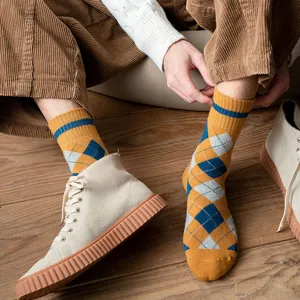 Close-up detail of men's argyle pattern terry socks providing winter warmth and style