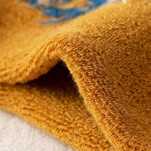 Close-up macro view of thick yellow terry fabric for men's warm winter socks details