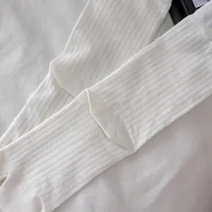 Detail shot of white ribbed split two toe socks texture closeup showing soft cotton knit fabric.