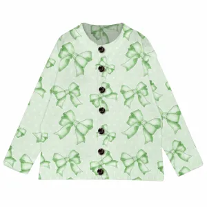 Close-up of a light green knit cardigan with an all-over bow print and dark buttons