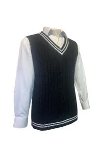 Detail view of unisex cable-knit V-neck vest with white stripe accents and white shirt.