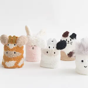 Soft coral fleece socks with cute cartoon animal designs for winter warmth and home wear.