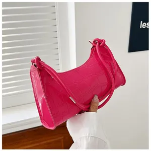 Close-up detail of a bright pink glossy stone pattern underarm bag featuring knotted straps