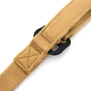 Tactical rifle sling detail shot, durable khaki nylon webbing with black metal hardware.