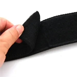 Close-up detail of black tactical belt with adjustable hook-and-loop fastener system