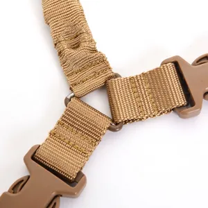 Close-up detail of heavy-duty tactical sling buckle and tan nylon webbing connection