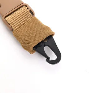 Close-up macro detail of a tactical sling featuring black HK hook and tan webbing