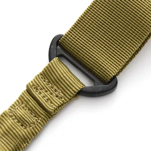 Close-up detail of outdoor tactical strap webbing with black buckle and reinforced stitching.