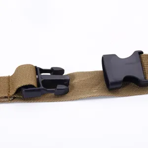 Macro view of tactical sling showing quick-release plastic buckle and tan webbing