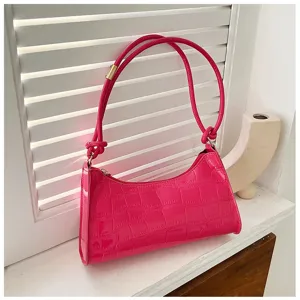 Detailed macro view of a vibrant hot pink stone pattern baguette shoulder bag for women