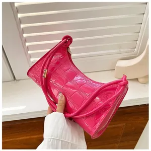 Detailed view of hot pink croc-embossed underarm bag with gold-tone hardware