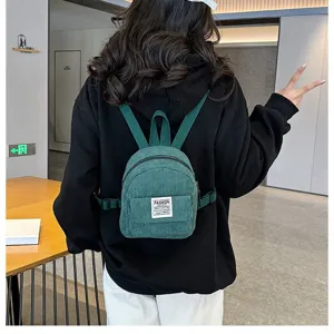 Stylish green corduroy mini backpack for women shown worn on back for daily casual use