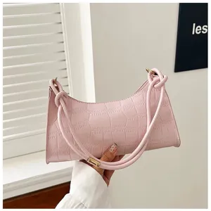 Close-up detail of a pink stone pattern underarm bag with knotted shoulder strap design
