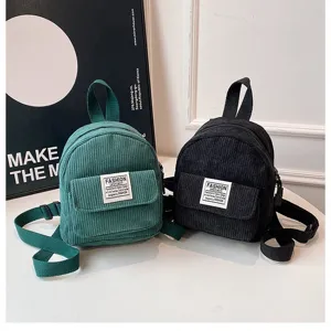 Detailed view of mini corduroy backpacks in green and black for women's casual fashion