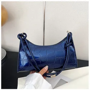 Glossy blue stone pattern underarm bag featuring stylish knot detail on shoulder strap