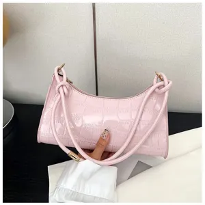 Detailed view of a pink glossy crocodile texture underarm bag for women's fashion