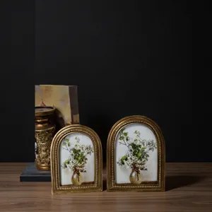 Vintage ornate golden arched photo frames featuring elegant white floral decorative art prints