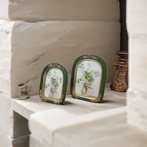 Close-up of vintage French green resin frames with ornate gold floral details