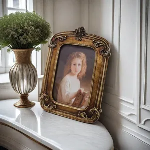 Vintage ornate gold resin photo frame displayed on an elegant marble tabletop