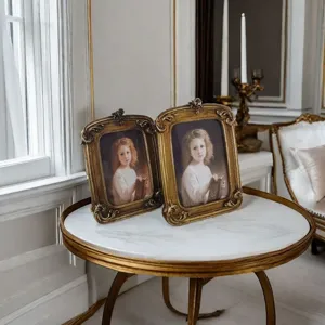 Vintage European resin photo frames with gold embossed details on marble table