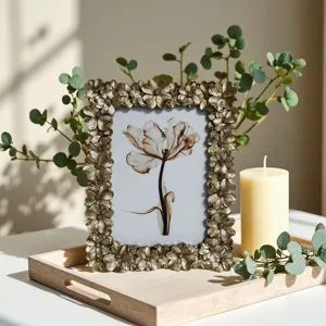 Detailed view of the vintage resin photo frame with intricate floral relief design for home decor.