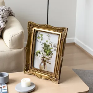 Detailed view of vintage gold embossed resin photo frame in a cozy French home setting