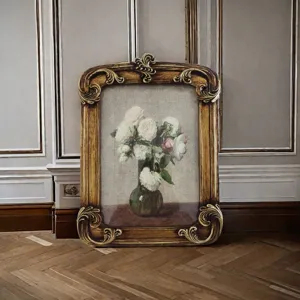 Close-up of a vintage French resin picture frame featuring ornate carvings and floral art