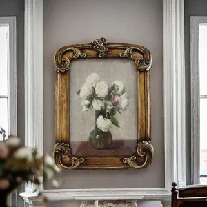 Vintage French style carved resin photo frame displayed on a decorative wall panel