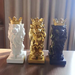 Detailed view of modern geometric lion sculptures featuring gold crowns and resin material.