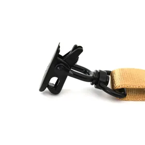 Detail view of tactical sling metal hook and khaki nylon webbing strap connector component.