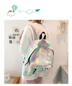Pastel color splash canvas backpack with star patterns and decorative chain detail.