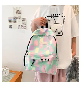 Preppy style student backpack featuring a pastel nebula print and decorative silver chain