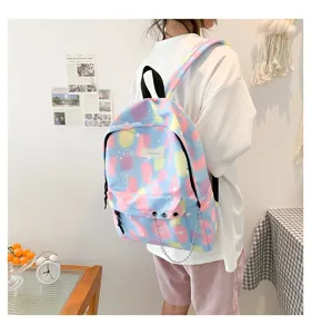 School backpack for girls with pastel watercolor pattern and silver chain detail on model