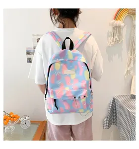 Colorful aesthetic canvas backpack worn by a student in a casual indoor lifestyle setting