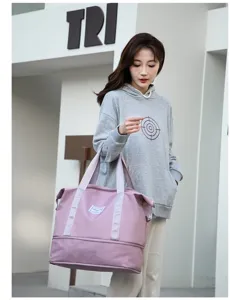Modelo femenina asiática sosteniendo una gran bolsa de viaje rosa en un entorno urbano