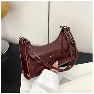 Close-up detail of a glossy burgundy stones pattern underarm shoulder bag for women