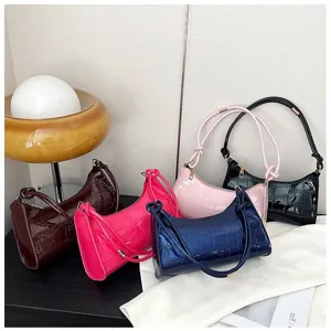 Various colors of stone texture underarm bags displayed in a modern lifestyle setting