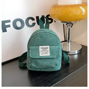 Detailed macro shot of a green corduroy mini backpack featuring a fashion instinct label