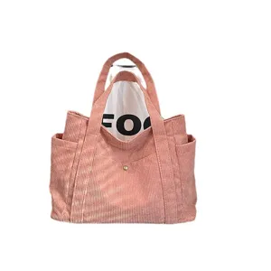 Moderna borsa tote in velluto a coste rosa con grande tasca frontale per uso quotidiano