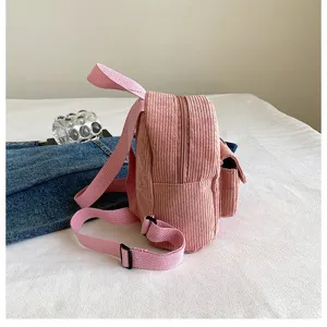 Side view detail showing the soft corduroy texture of a stylish pink mini backpack