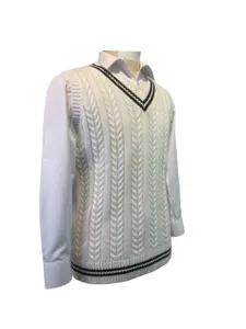 White cable knit V-neck vest with contrast stripes over a white shirt