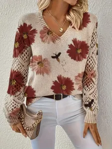 Close-up of elegant bohemian floral print on a white V-neck long-sleeved knit sweater top
