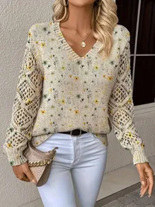 Close-up of bohemian floral V-neck knit sweater with hollow-out sleeve details.