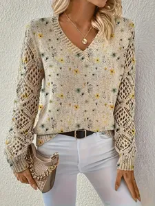 Close-up of elegant floral V-neck sweater featuring unique hollow-out knit sleeves