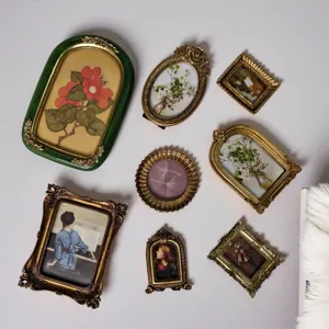 Collection of vintage gold relief resin photo frames in French court style on wall