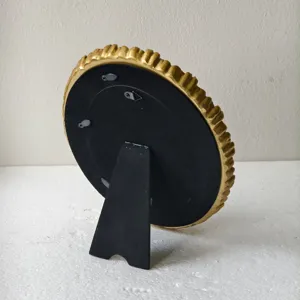 Vintage gold picture frame easel back detail view showcasing sturdy black stand and hooks.