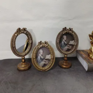 Set of three vintage European gold carved tabletop photo frames and oval vanity mirror