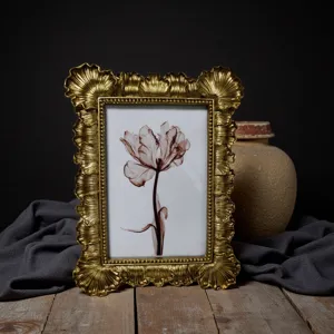 Vintage baroque gold picture frame with embossed floral art, retro decorative desktop frame.