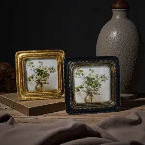 Detailed macro shot of vintage European embossed picture frames featuring floral oil prints